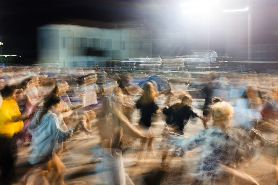 Blurred crowd of people viewed from a distance at an event