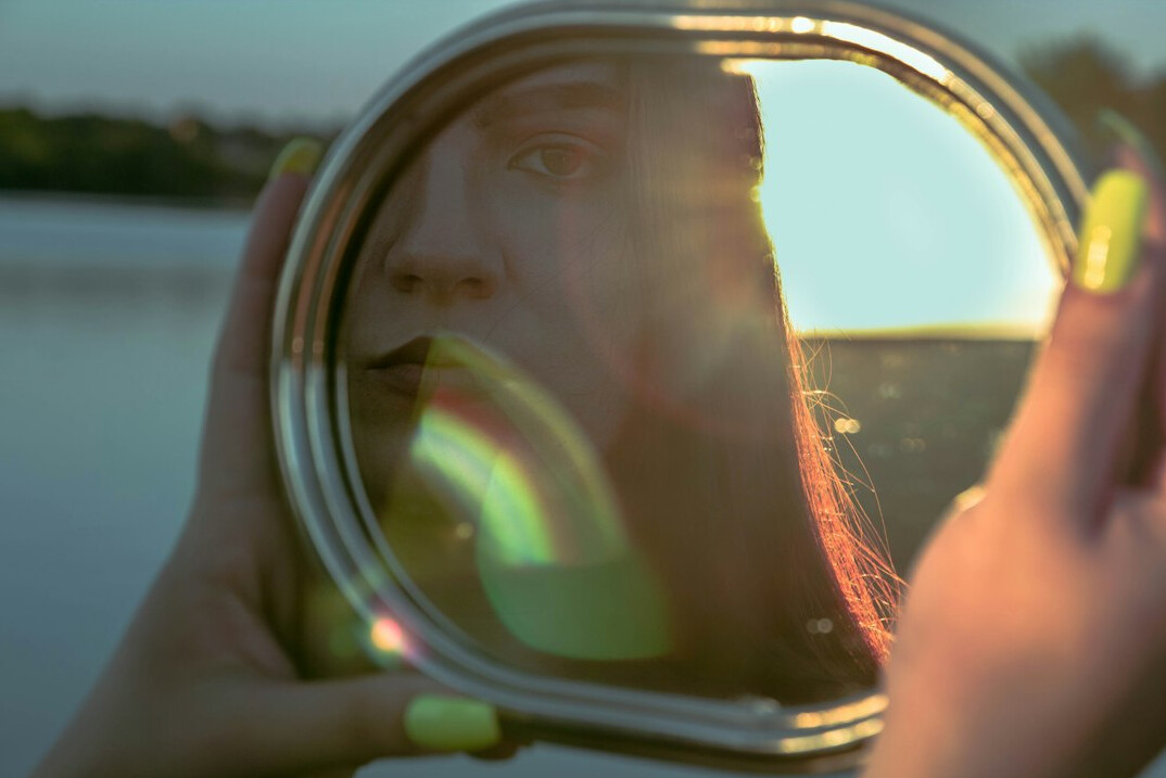 person reflecting in mirror